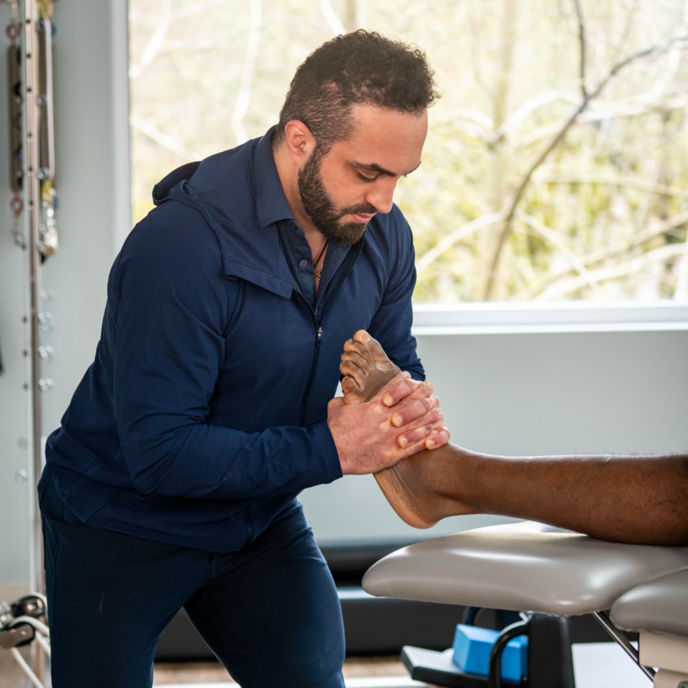 A therapist massages a patient's foot
